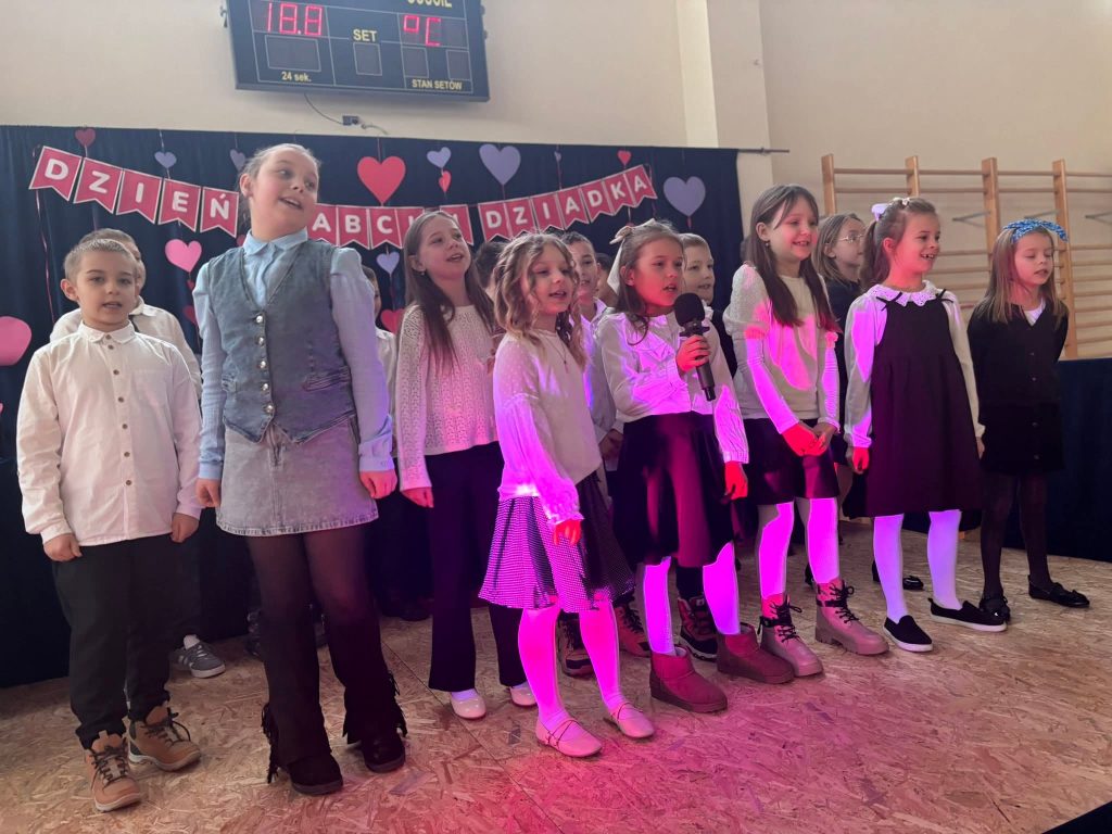 Dzieci śpiewają do mikrofonu.